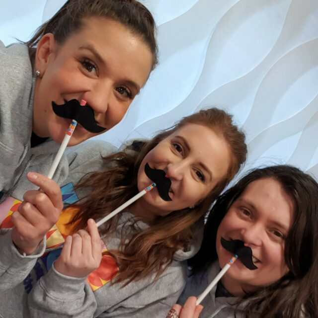 leanne kari and emma holding a moustache