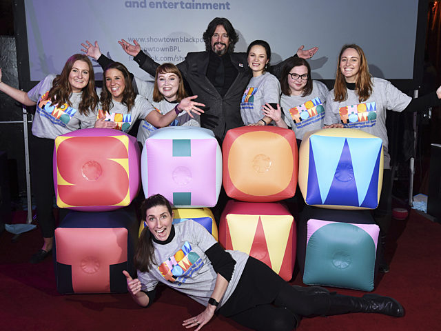 Showtown team and Laurence Lewellyn Bowen posing behind a large Showtown logo.