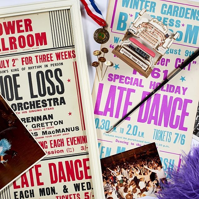 A photograph of dance objects with a tower ballroom poster, a photo of dancers and a medal