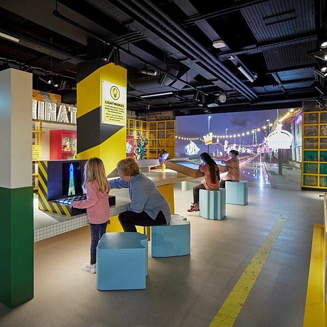 Illuminations gallery at Showtown.  Family sat at interactive tables creating light show.